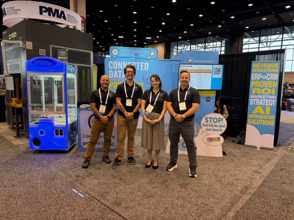 protocol 80 team in front of claw machine and trade show booth